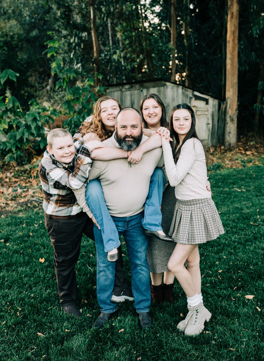 Family of 5 posing in front of tall trees, San Luis Obispo, CA
