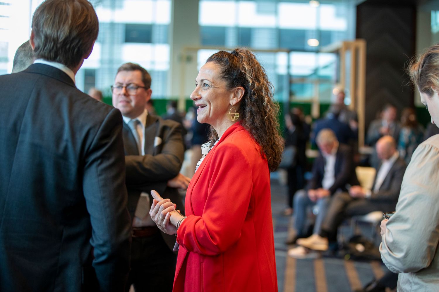 Conference attendees engaged in conversation during a business networking event.