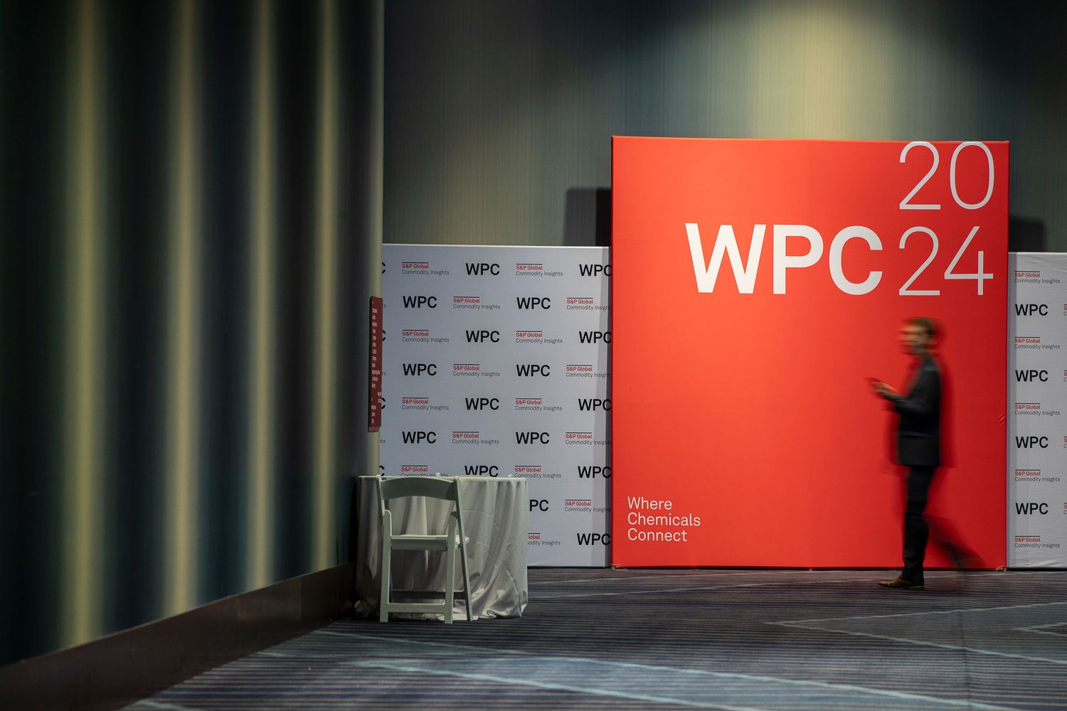 Conference stage setup with red WPC24 branding and logo wall backdrop.