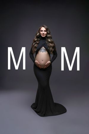 Pregnant woman in black crop top and skirt cradling baby bump, with MOM text overlay on dark background.
