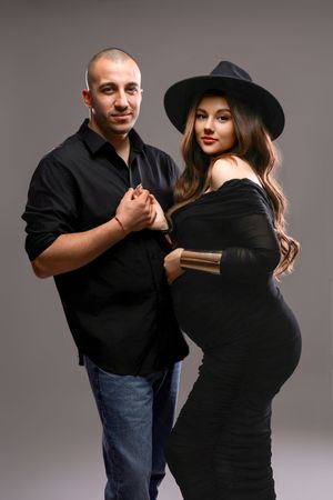 A couple demonstrates self-defense techniques in a series of five progressive photos against a gray studio backdrop.