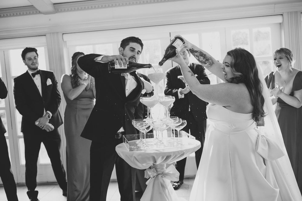 Bride and groom do a champaign waterfall.