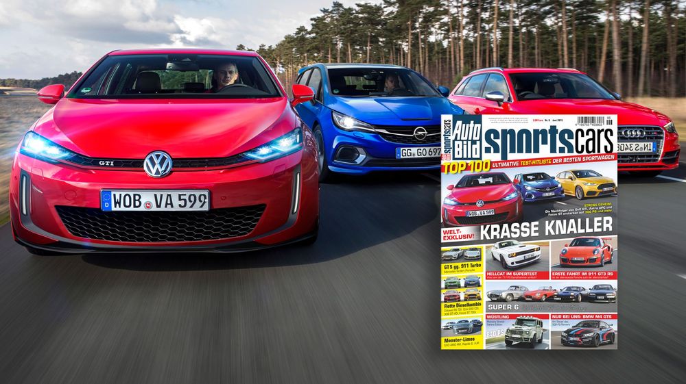 Three sporty compact cars displayed in red, pink and blue colors alongside a car magazine cover on a racetrack.