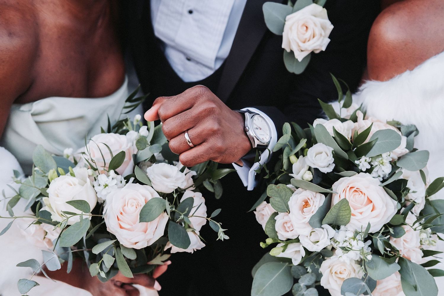 Elegant wedding bouquets featuring blush roses and greenery alongside formal attire.