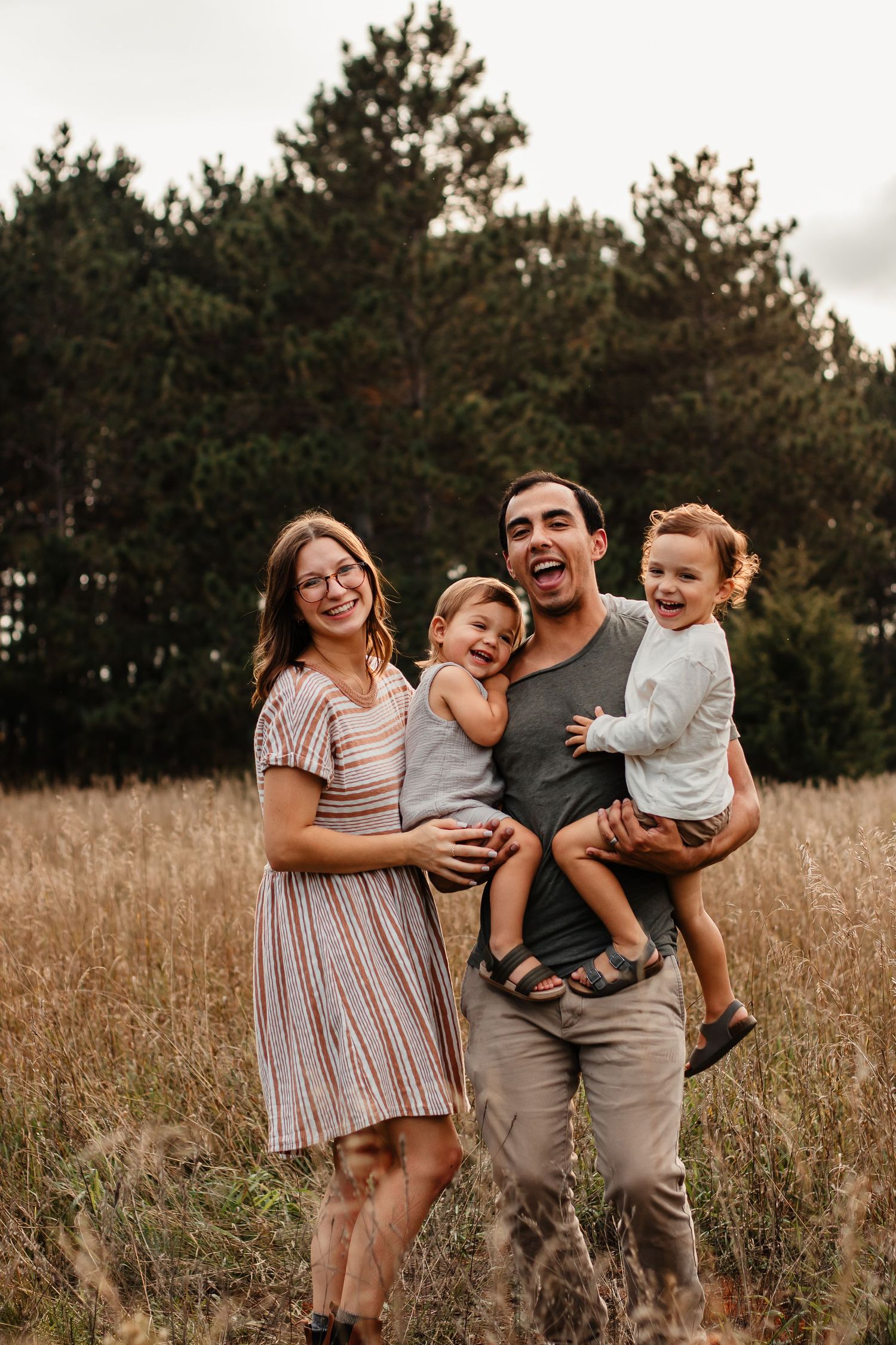 Bemidji family smiles in field family photo session.