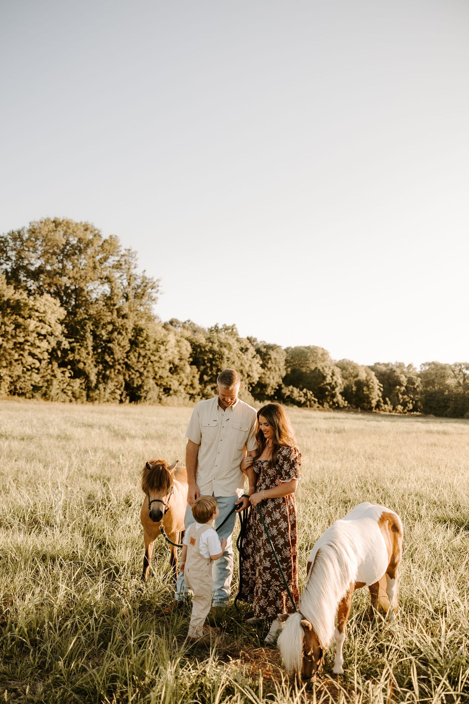 A couple in Gallatin, TN sharing an intimate moment in a field during their engagement photos.