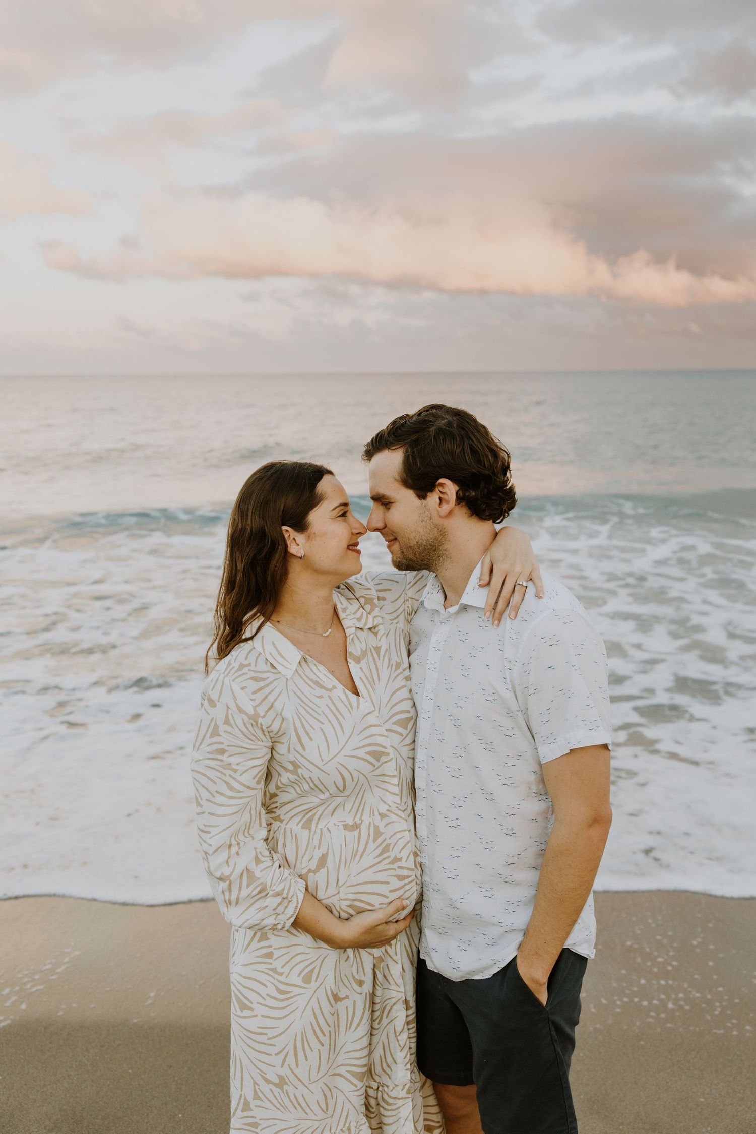Sunset Maternity Session in Palm Beach, Florida captured by Lindsay McDow Photography featuring a married couple on the beach
