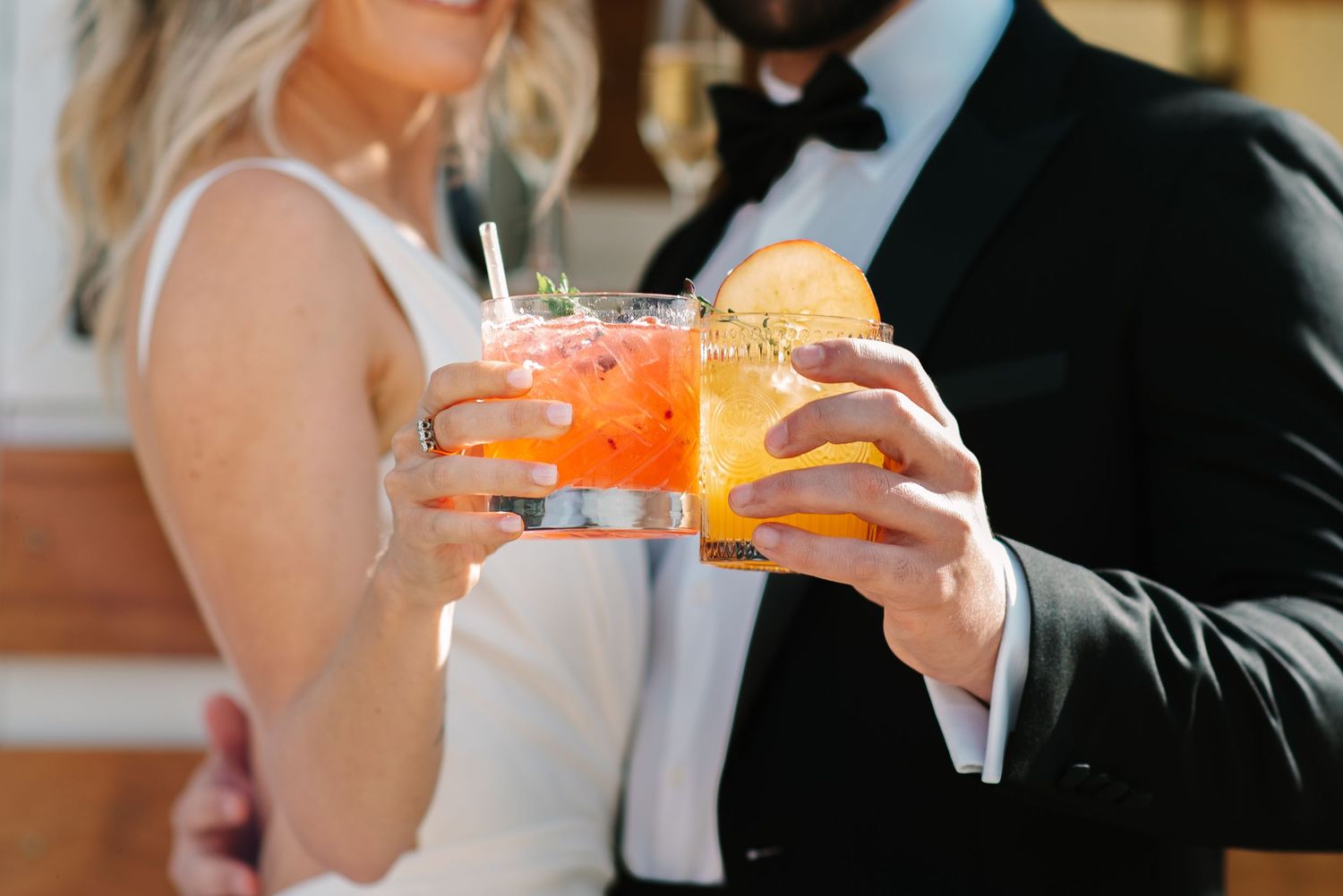 Close-up of hands toasting with champagne glasses at an elegant celebration.