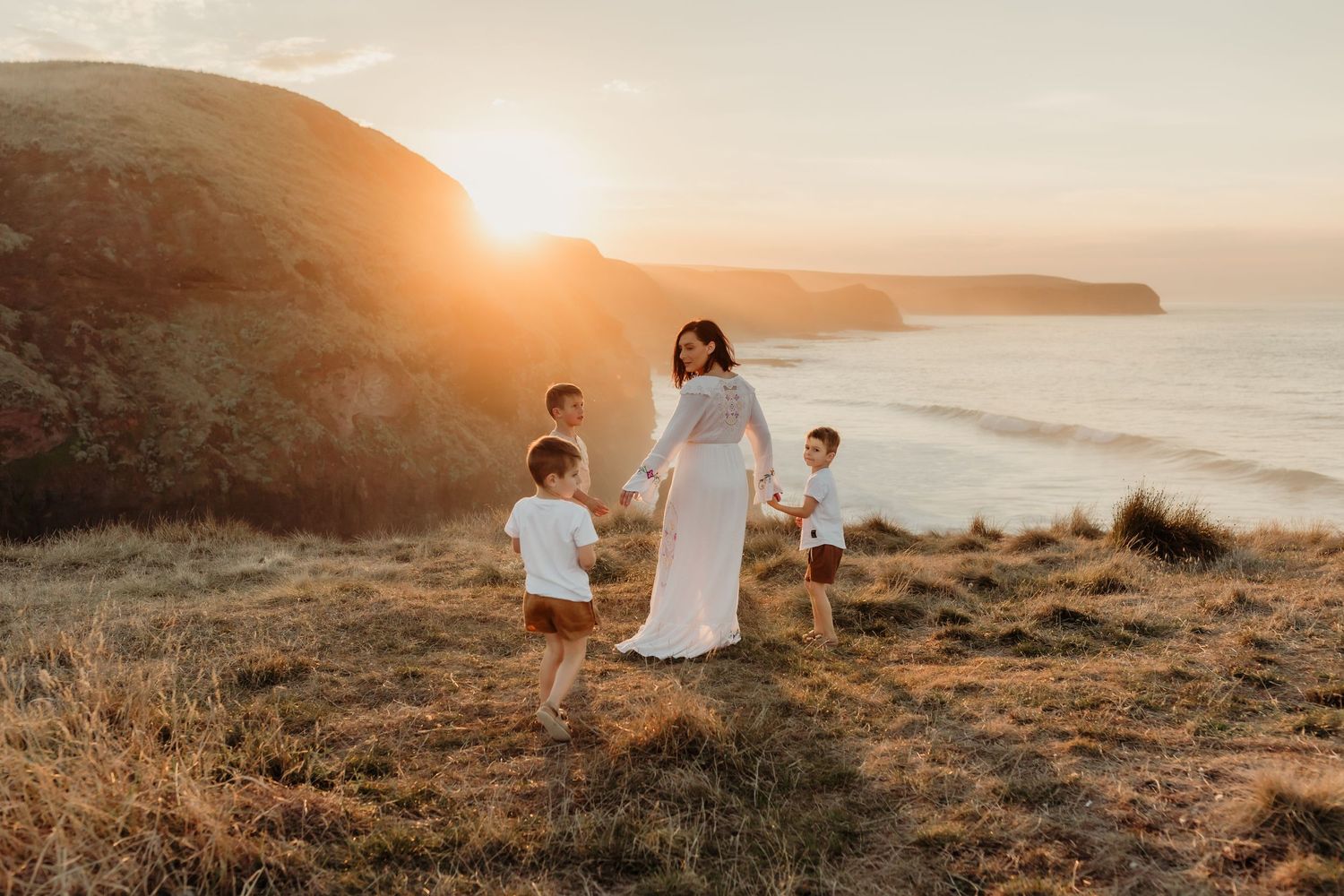 Emotive family photography capturing love & connection. Golden sunset, ocean views, and motherhood moments. Book your session today!