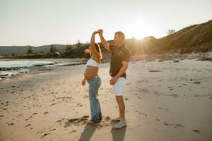 A romantic sunset dance on a sandy beach with golden sunlight streaming through.
