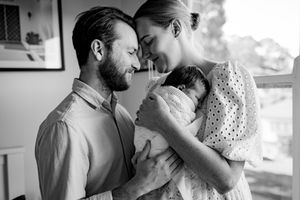 A romantic black and white photo series showing tender moments between a couple in formal wedding attire.