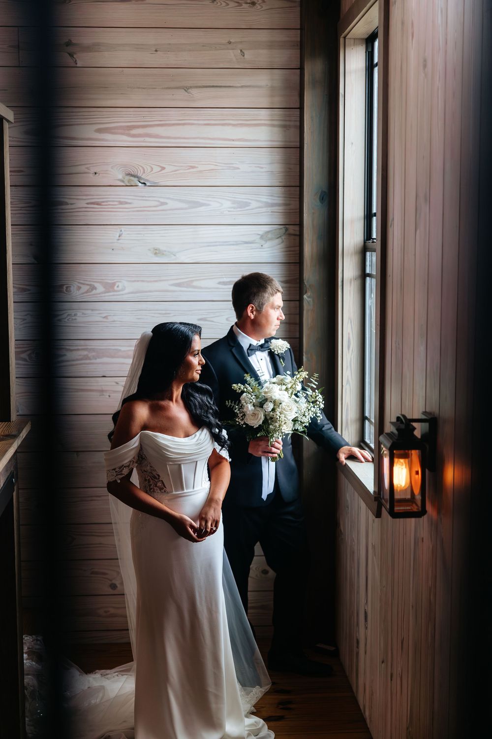 A series of romantic wedding photos showing a couple in a rustic wooden hallway with dramatic lighting and shadows.
