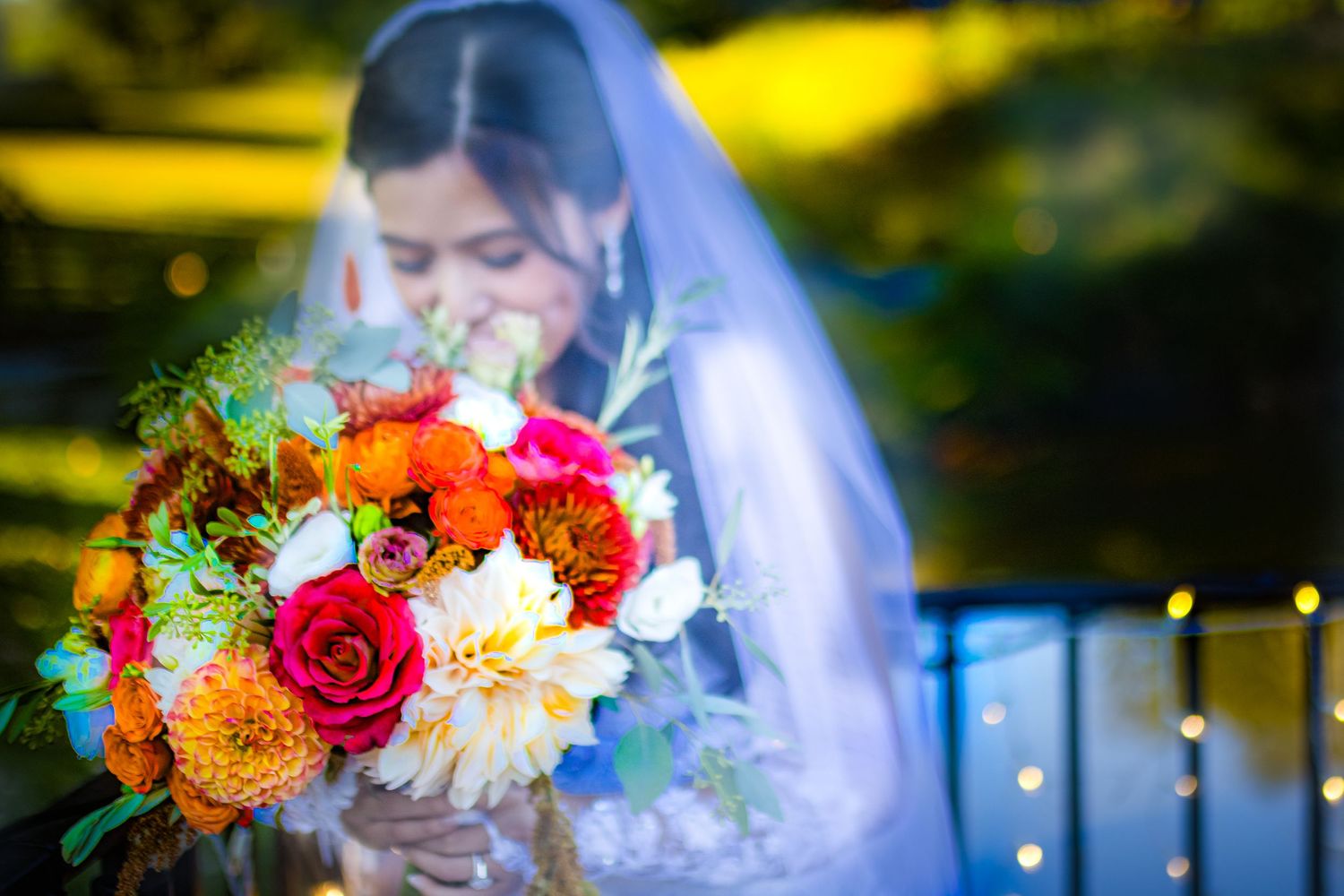 Vibrant bridal bouquet with roses, dahlias and mixed flowers in autumn colors.
