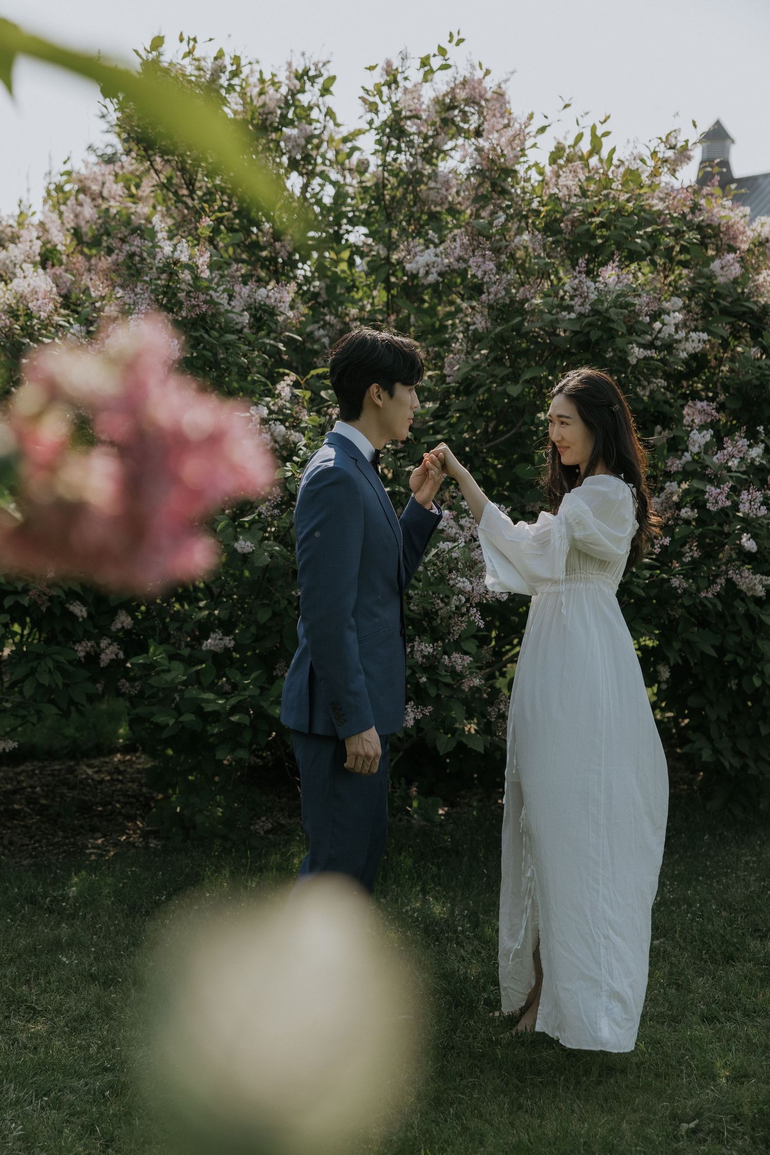 A romantic wedding portrait series showing tender moments between newlyweds in a sun-dappled garden setting.