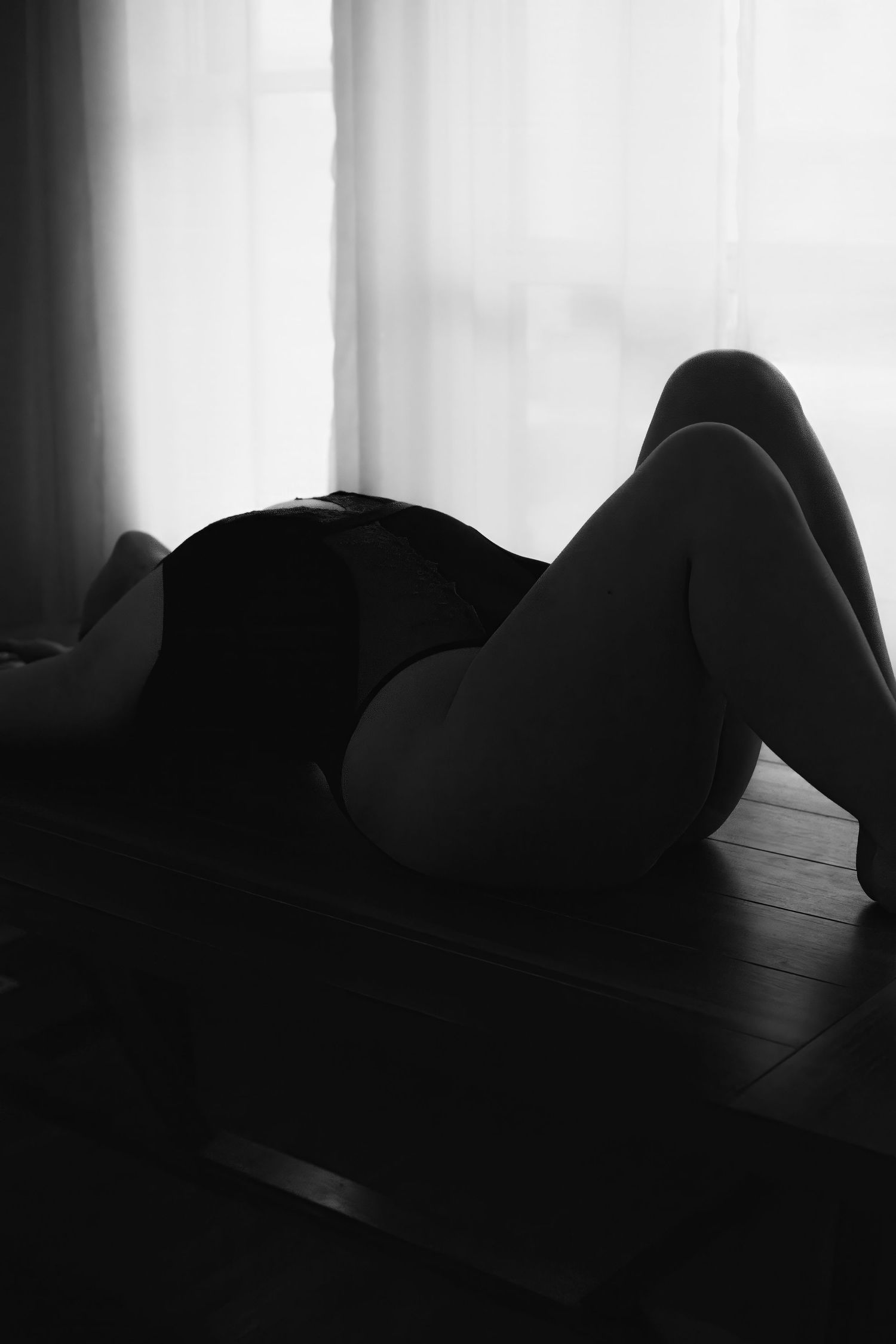 Artistic black and white silhouette series showing abstract curves and shapes against a light background.