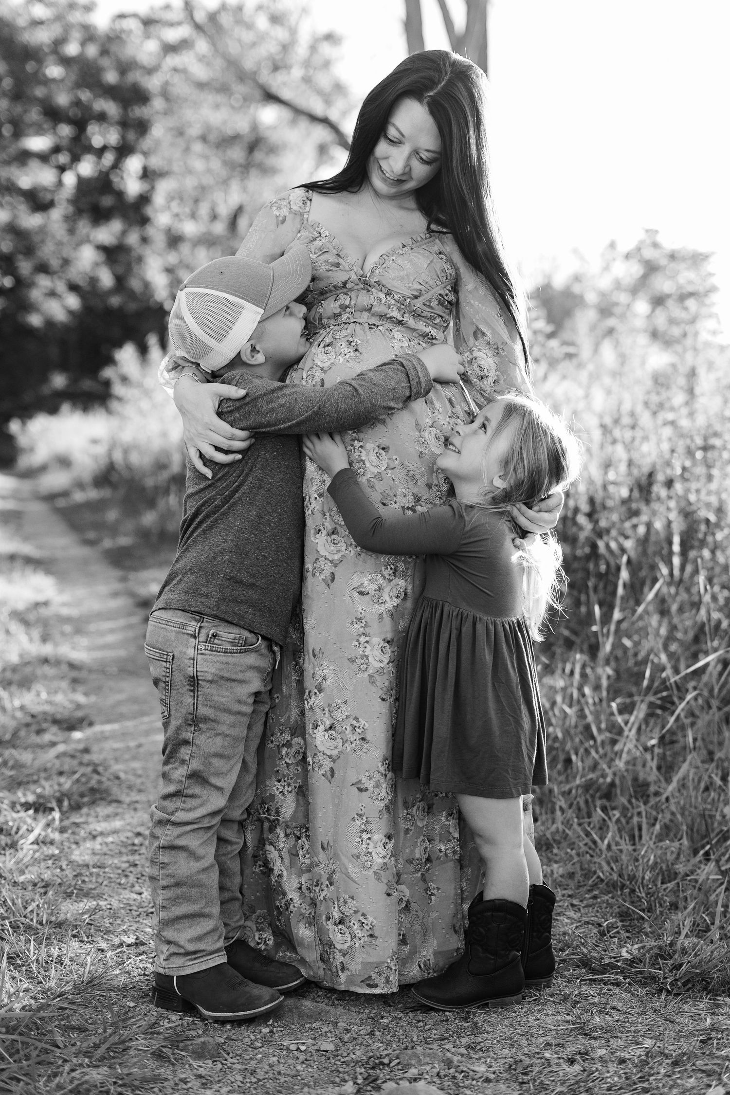 A tender moment between parent and baby outdoors with soft autumn bokeh in the background.