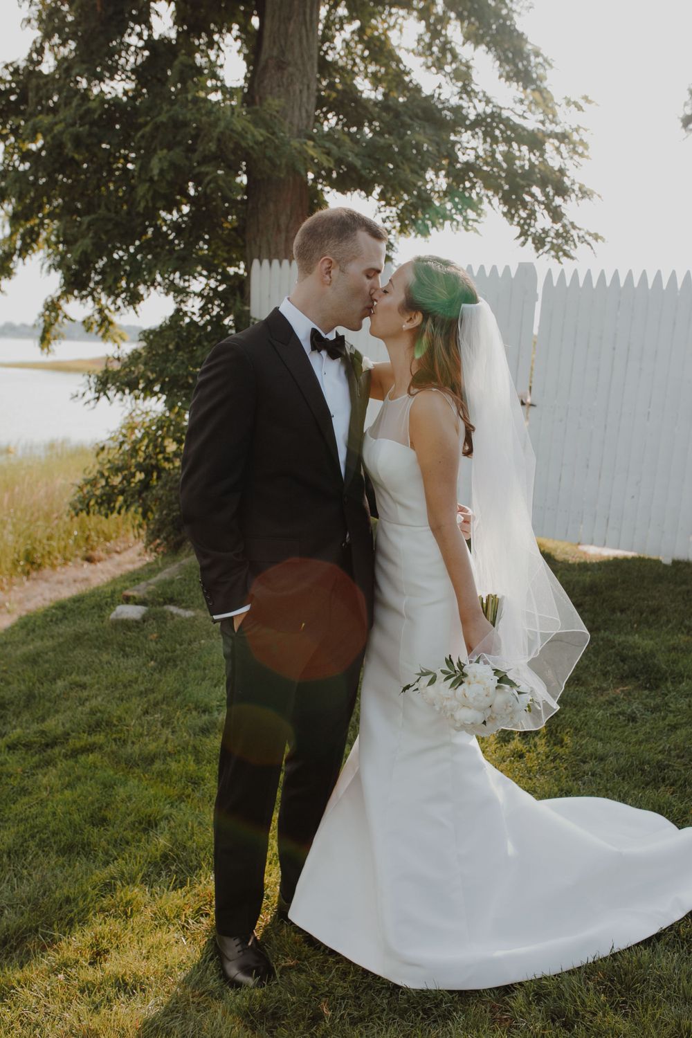 Romantic moment between newlyweds during outdoor wedding photoshoot.