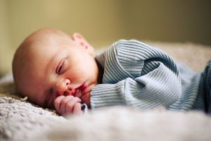 Close-up of mother’s hands cradling baby in Oklahoma City
