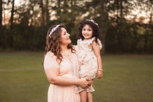 Styled maternity session with rust-colored dress in Moore