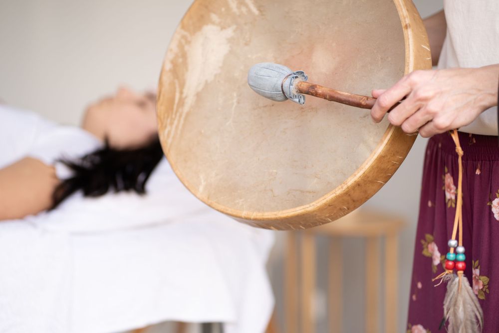 Close-up of drum and mallet during sound healing therapy session.
