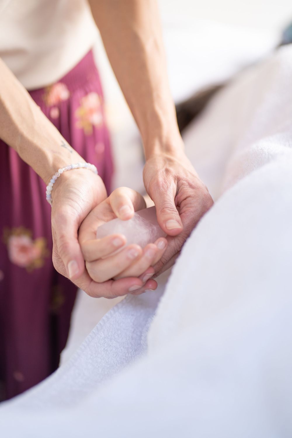 Close-up of hands performing a therapeutic massage technique on a client.