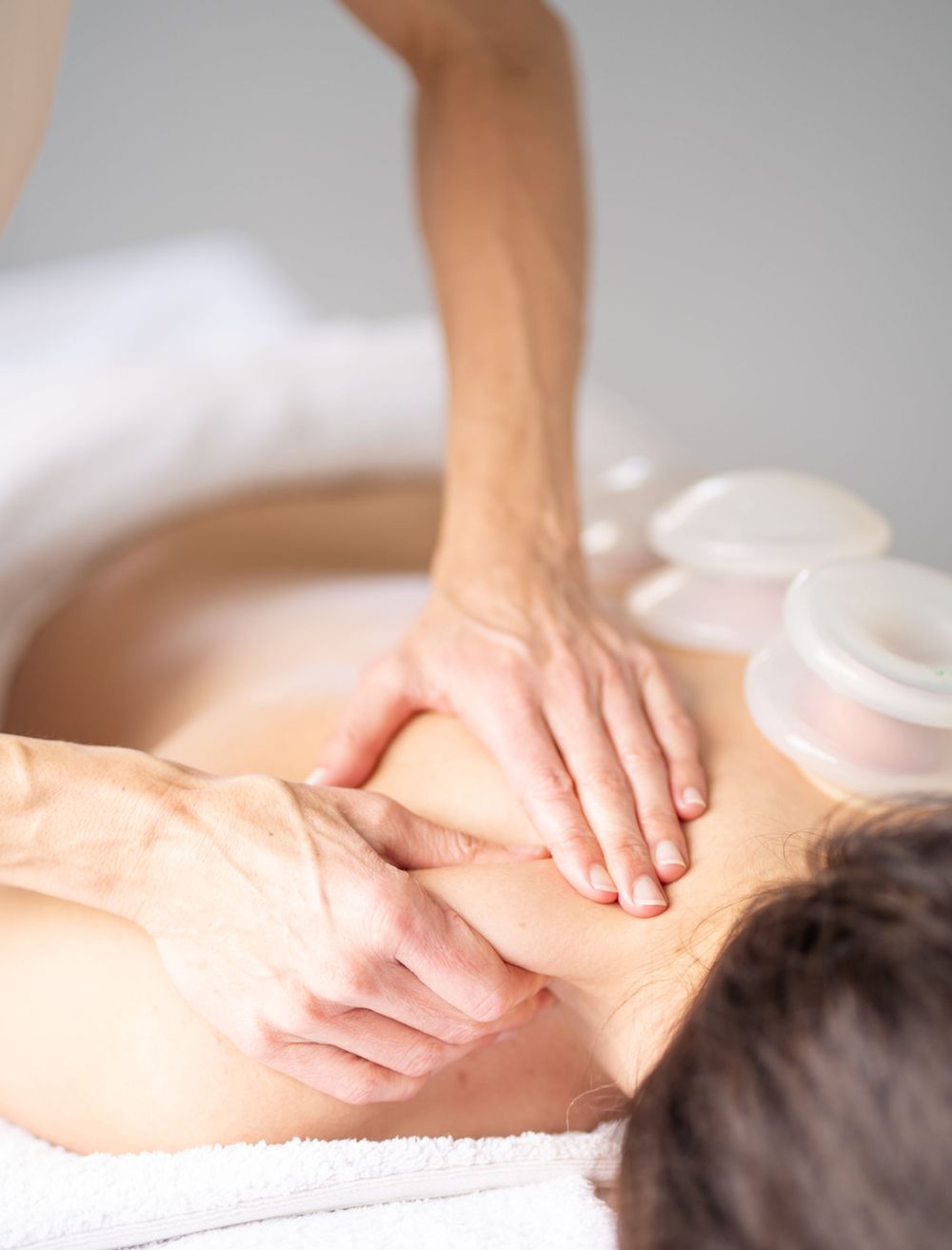 Therapeutic massage focusing on shoulder and upper back muscles.