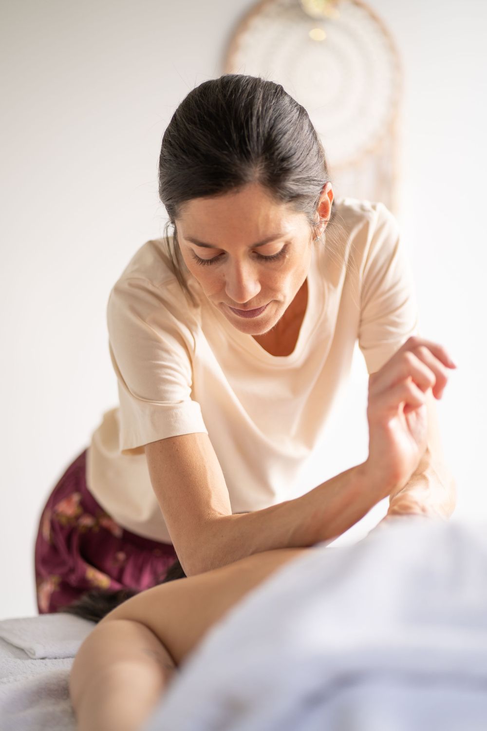 Massage therapist providing targeted treatment during a professional spa session.