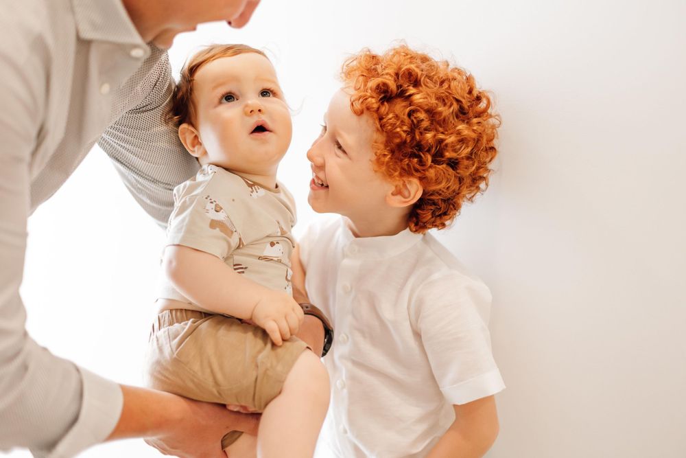 A joyful indoor family moment with gentle lighting.