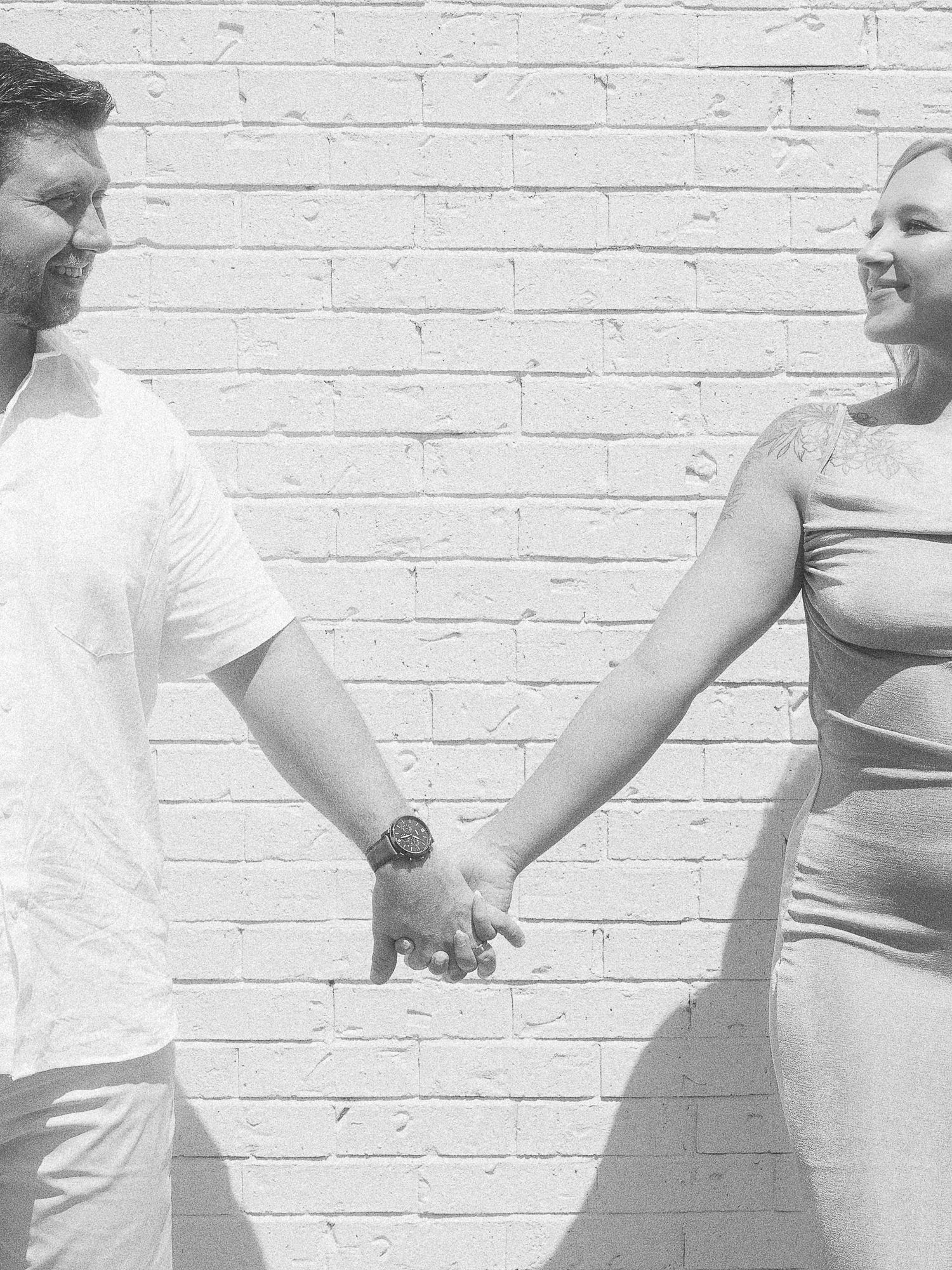 A tender moment captured in black and white showing a pregnancy journey through multiple progression photos.