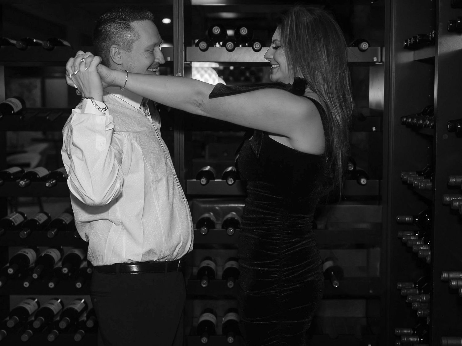 A dramatic scene in a wine cellar shows two people in a tense confrontation.