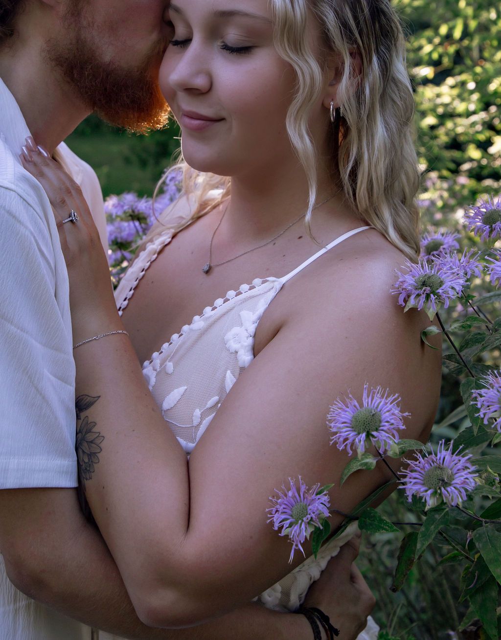Intimate close-up portrait among purple flowers in natural sunlight.