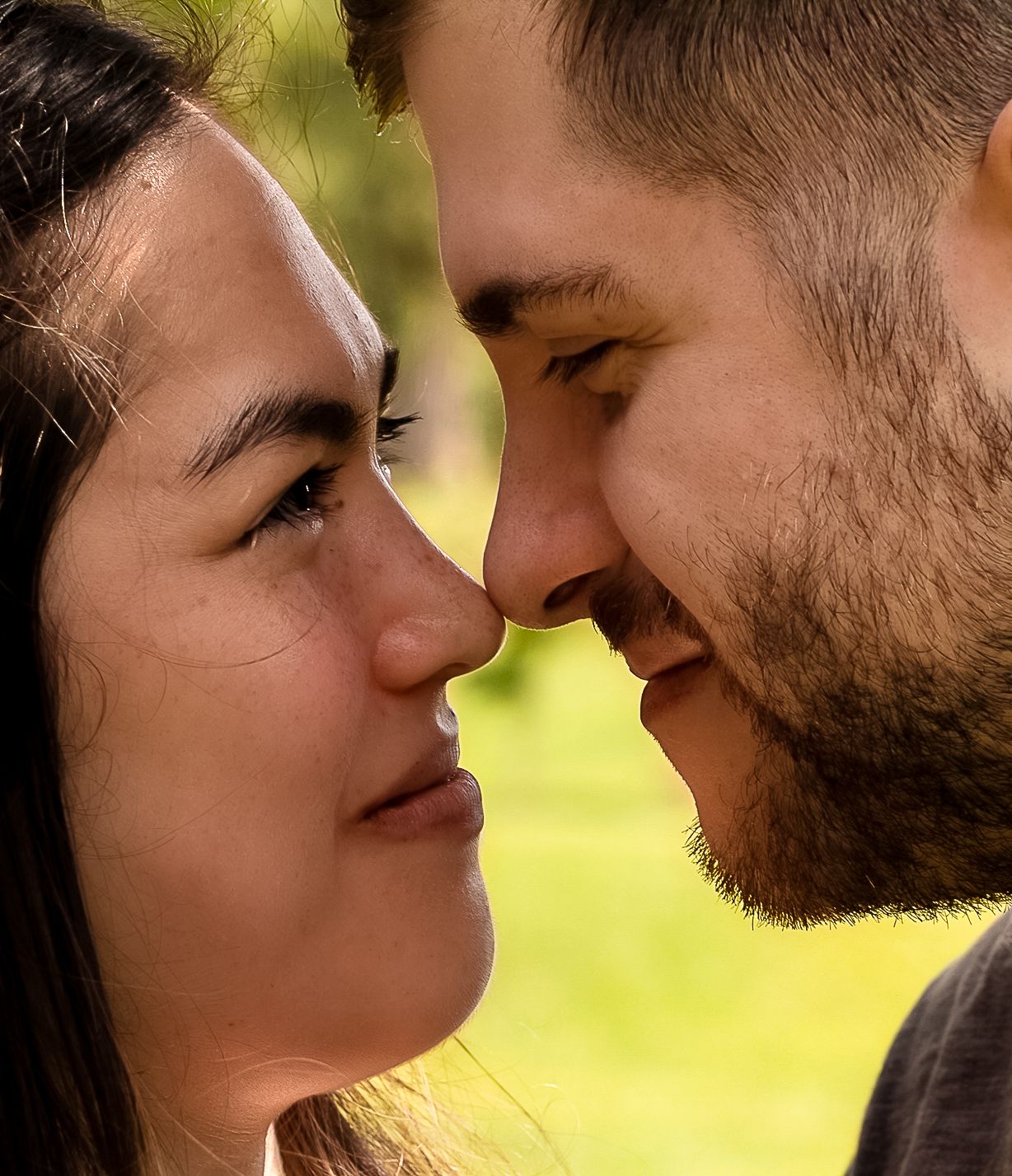 Intimate close-up photo series of a couple in soft natural lighting with their faces close together in tender moments.