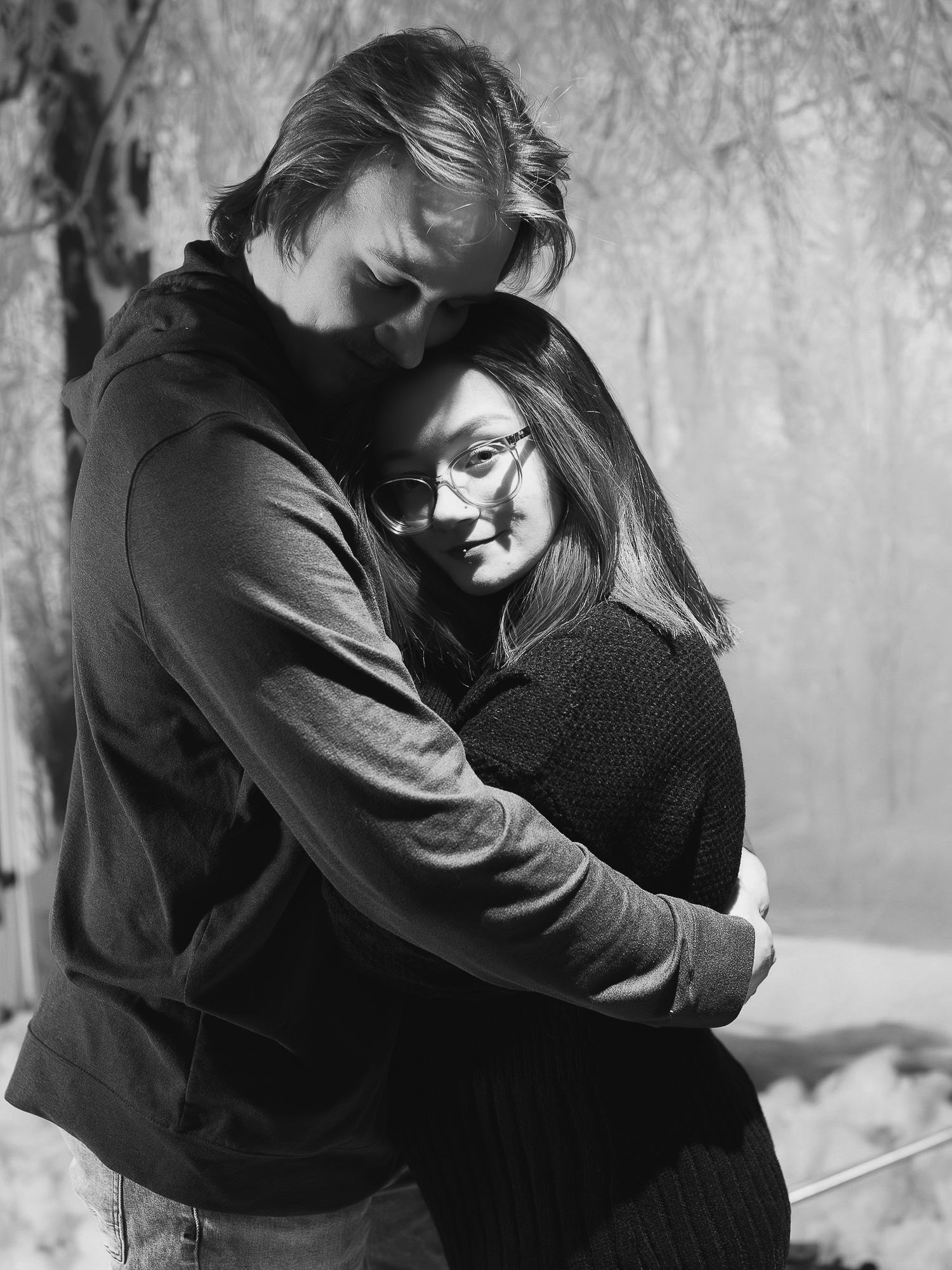 A romantic black and white photo series showing a couple embracing in multiple tender moments.