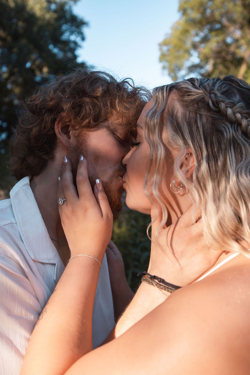 A close-up shot of a couple sharing an intimate moment in golden afternoon light.