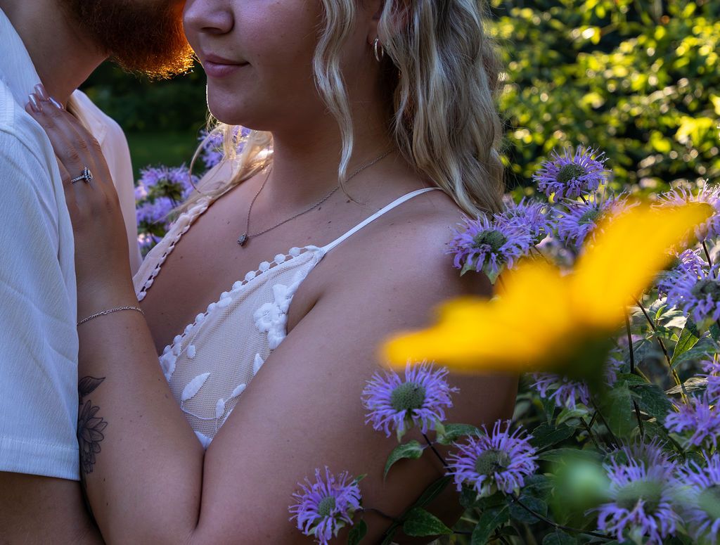 Close-up shot of an intimate moment surrounded by purple asters and yellow wildflowers.