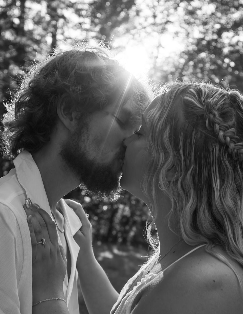 Black and white portrait of couple in intimate moment outdoors.
