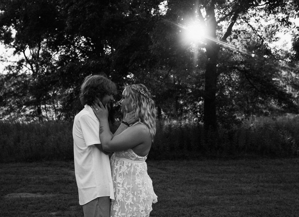 Black and white outdoor portrait with dramatic lighting and shadows.