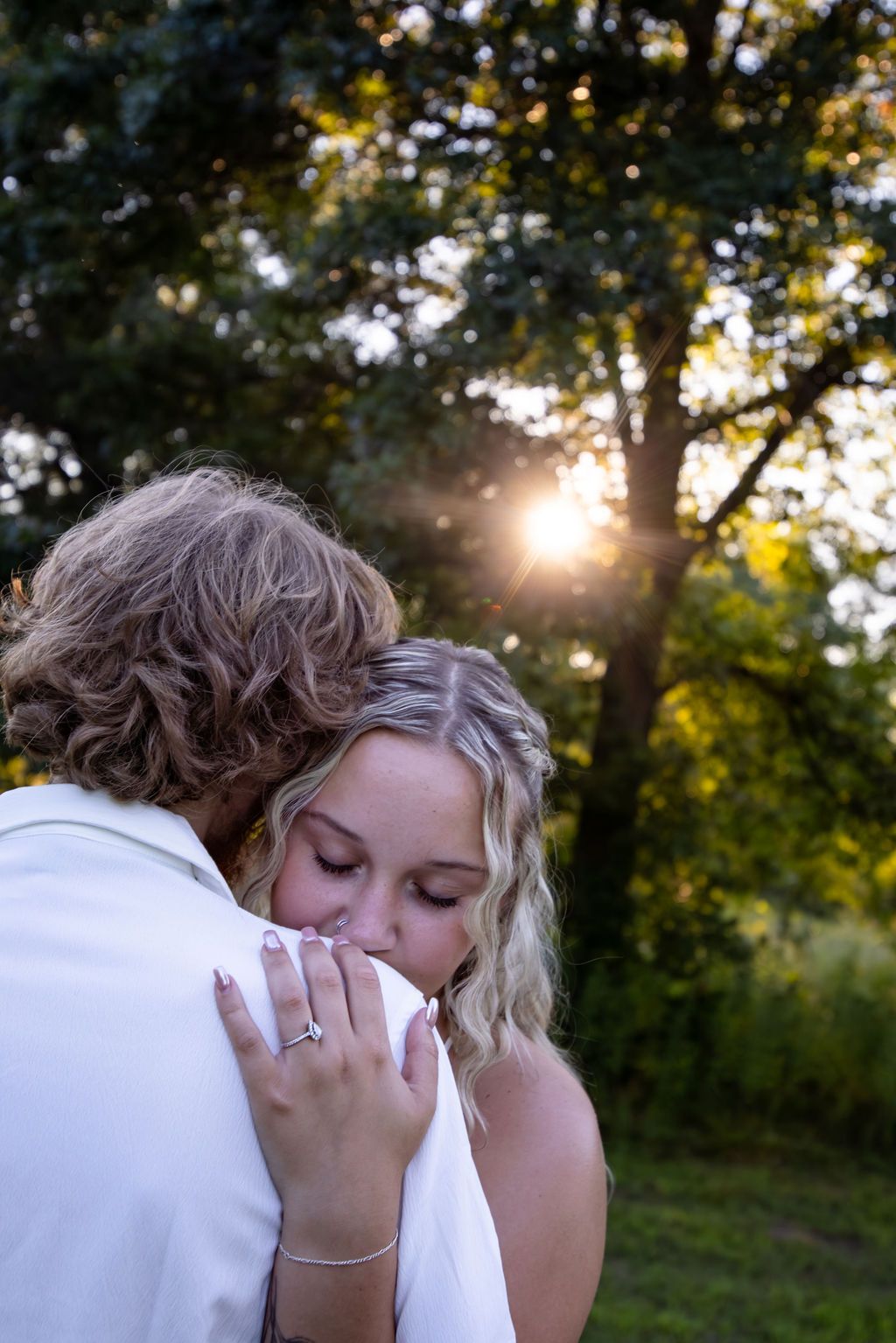 Emotional moment between a couple during an outdoor photoshoot at golden hour.