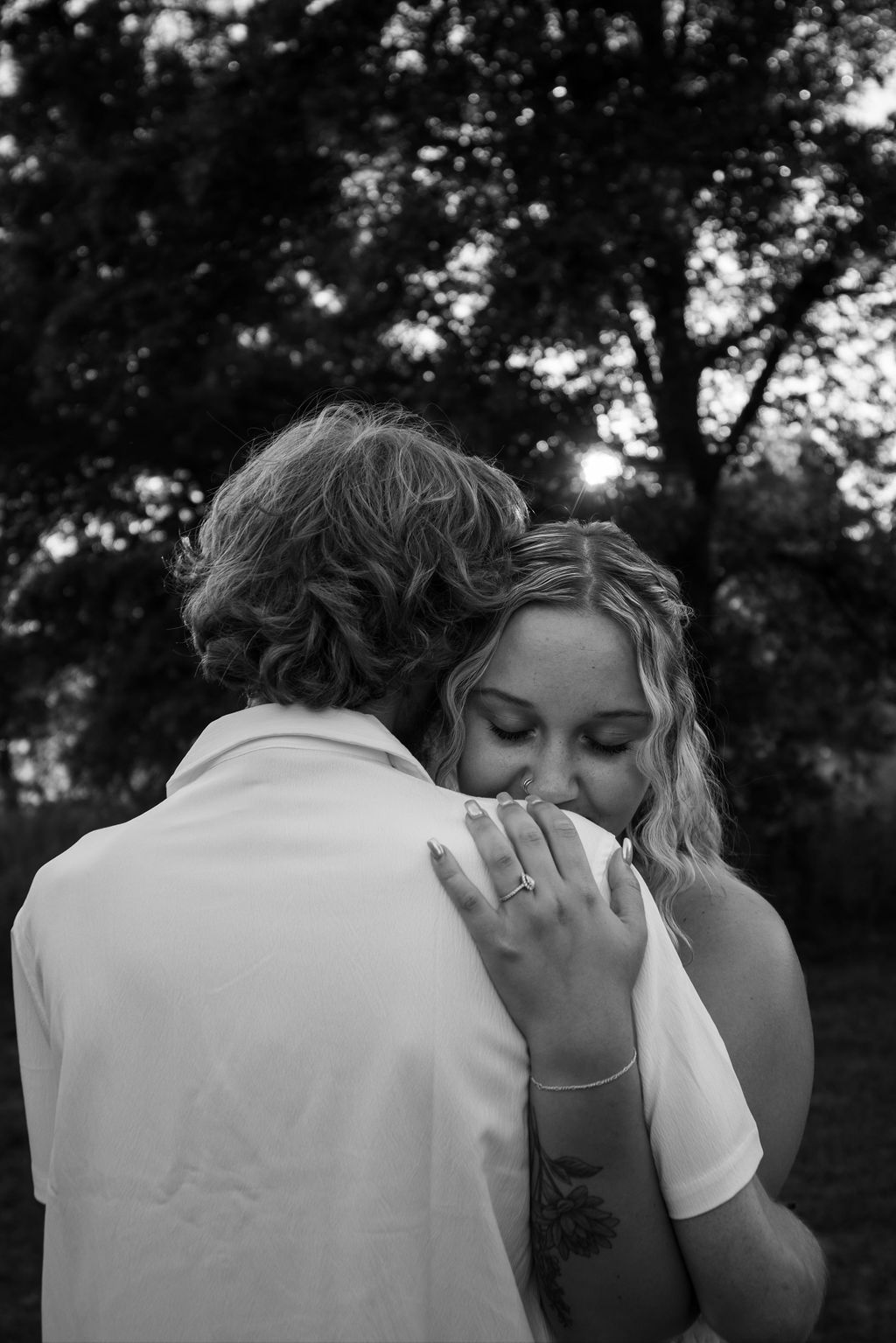 Black and white portrait of an intimate embrace outdoors.