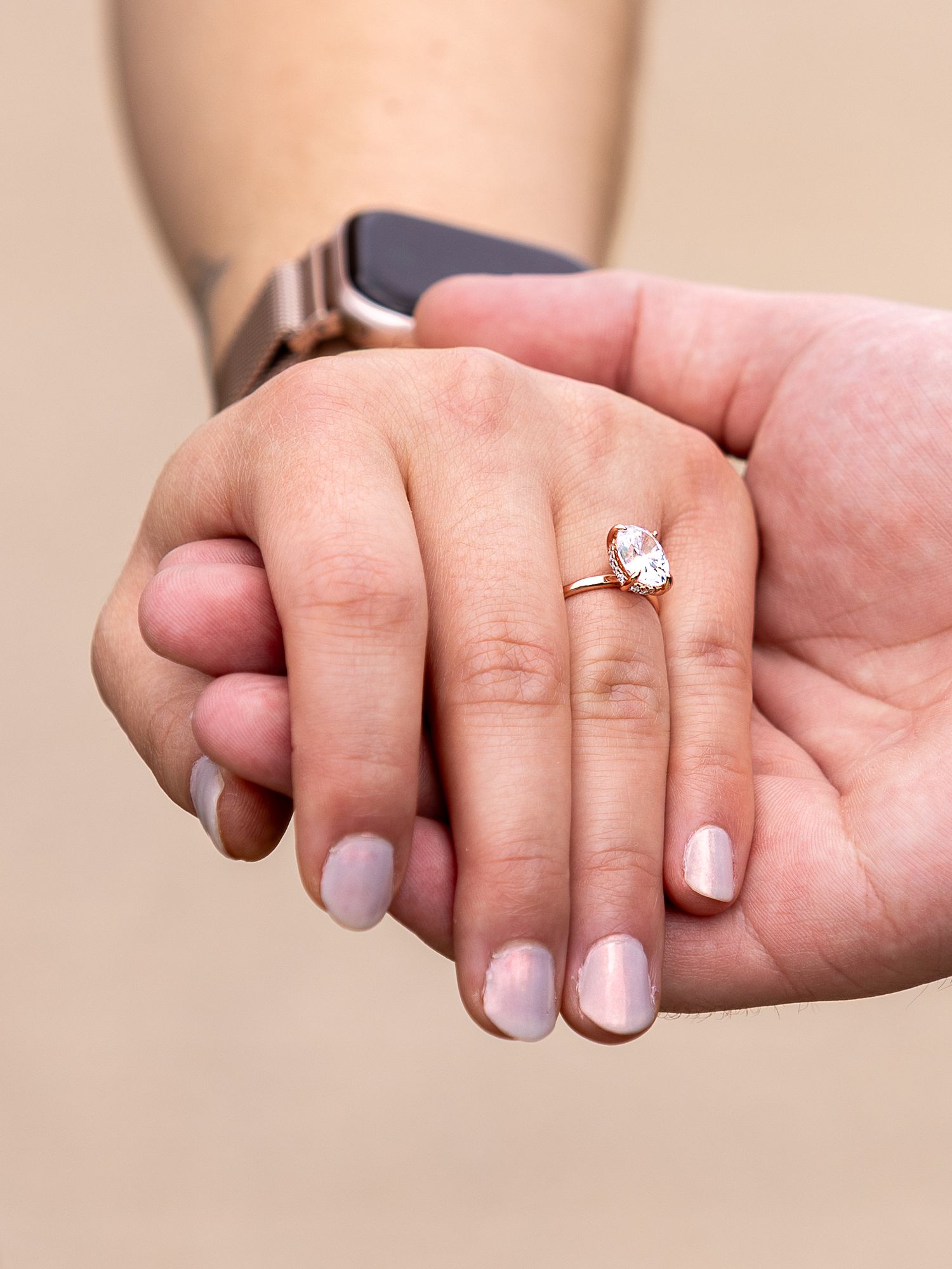 A sequence of close-up photos showing a couple holding hands with a sparkling engagement ring prominently displayed.
