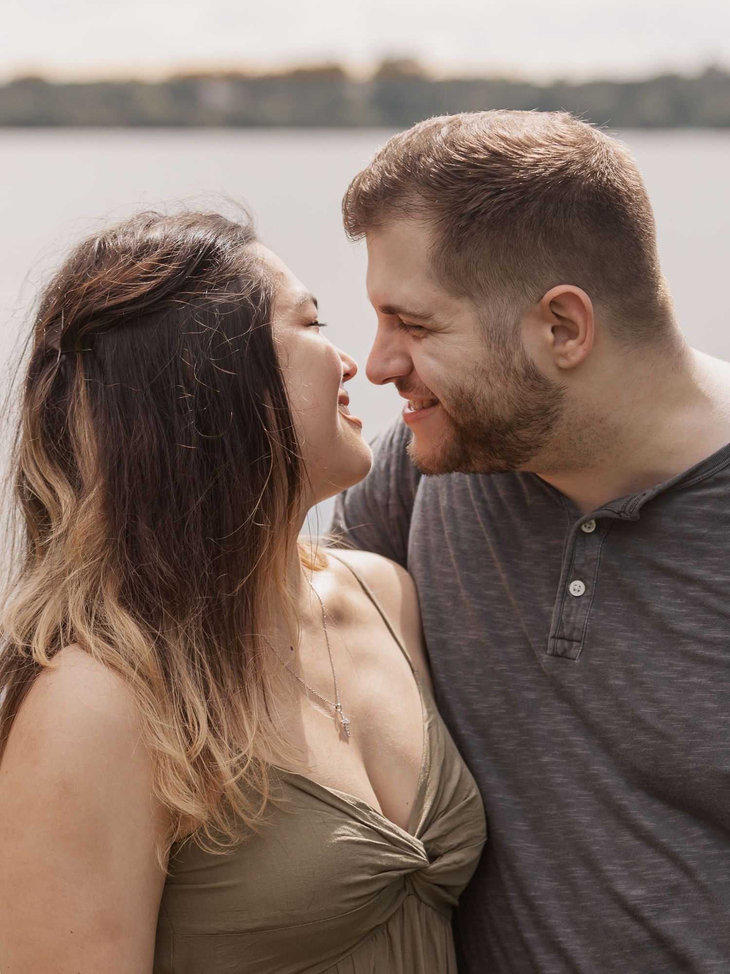 A romantic couple embracing at sunset by a lakeside shown in a series of intimate close-up shots.