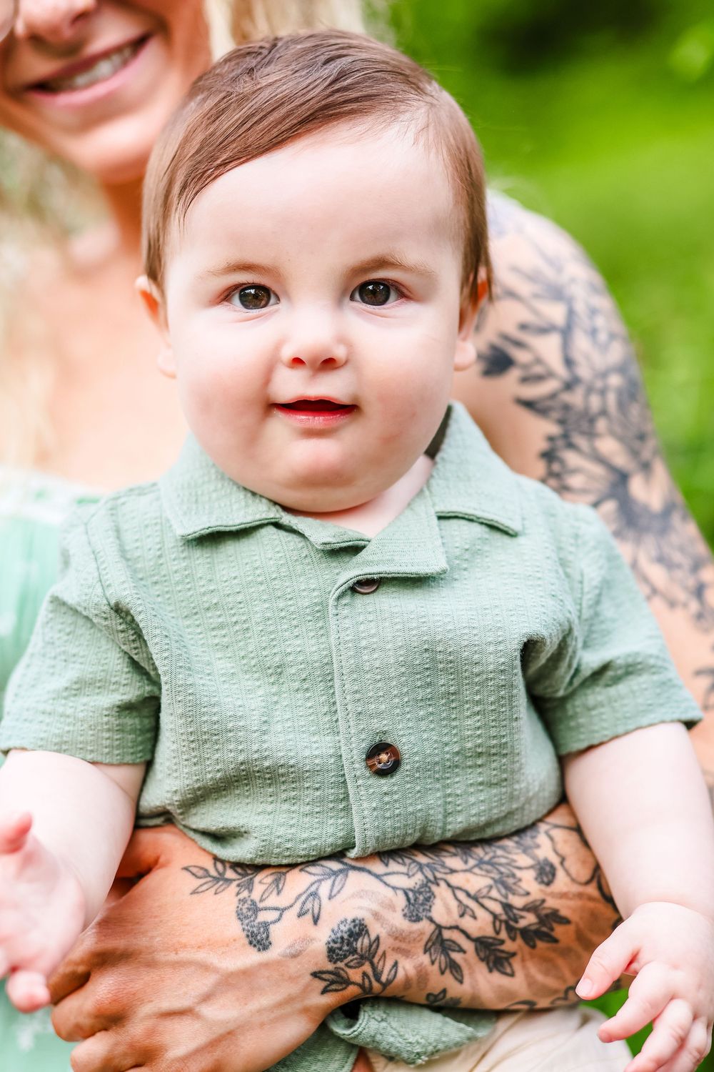 A candid image of a baby being held by his mother.