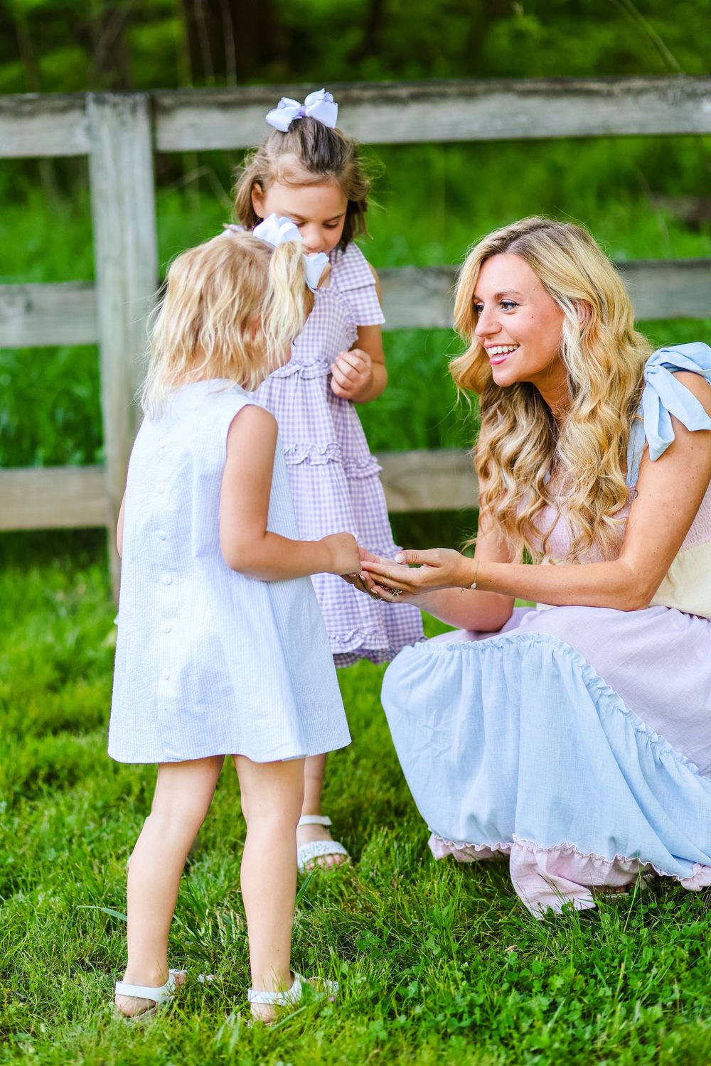 A candid image of a mother holding a flower that her daughter brought her, smiling.