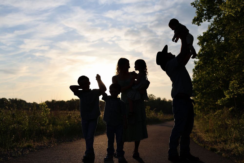 A silhouette image of a family at sunset.