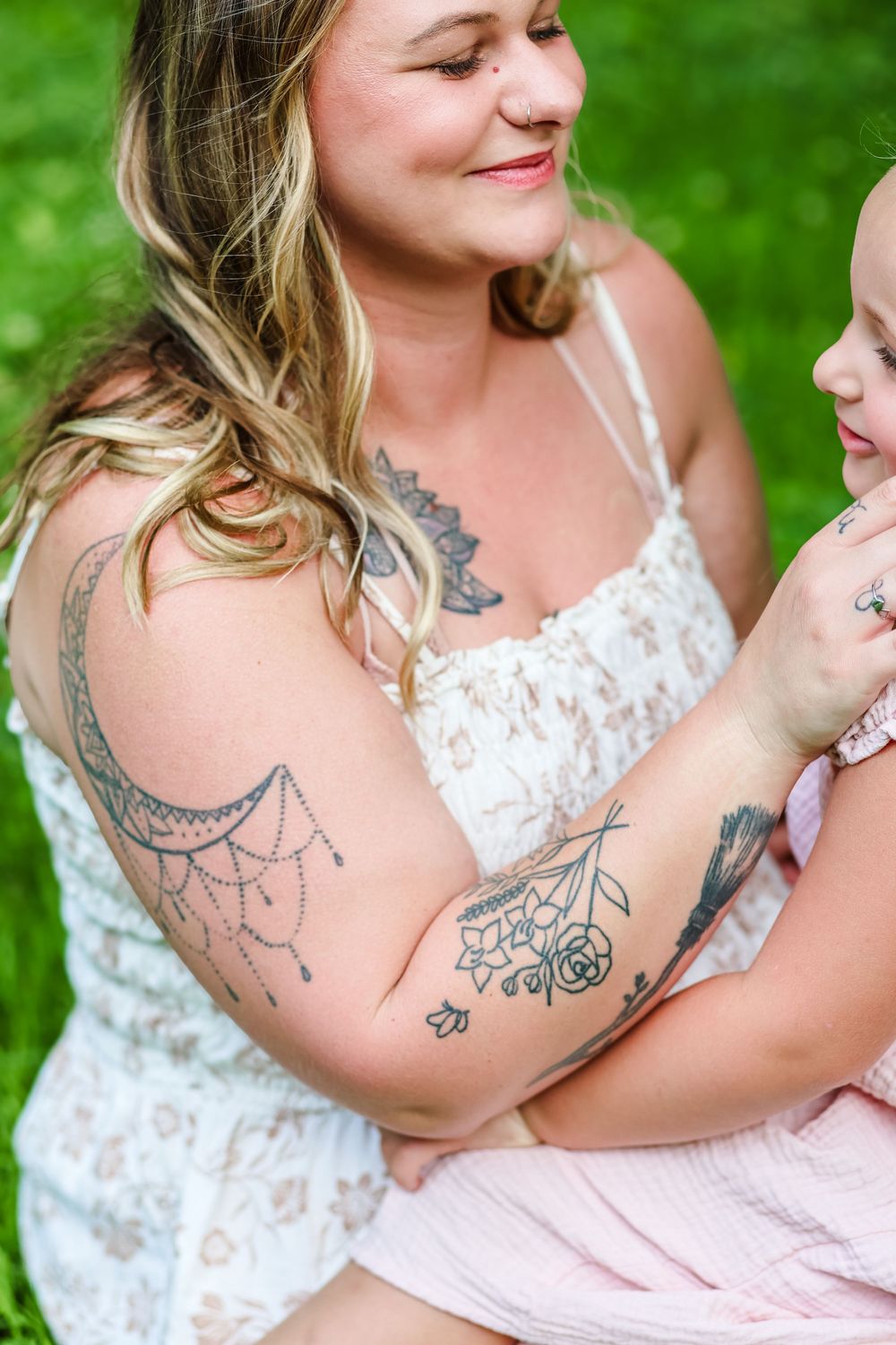 A candid image of a mommy and me photoshoot a mother holding her daughter.