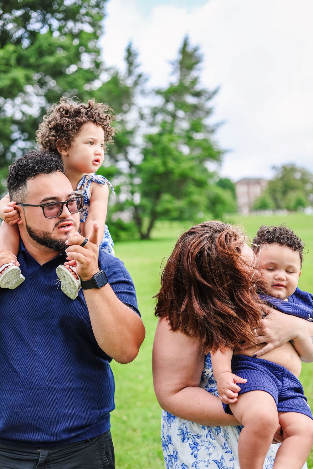 A candid picture of a family photoshoot in a field.