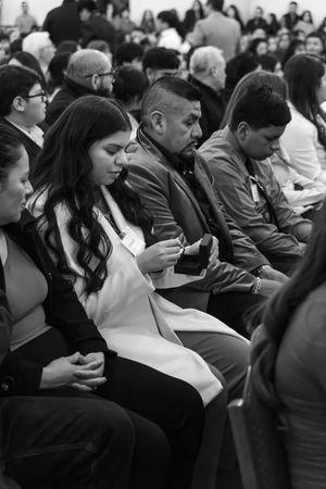 Black and white photo of a crowded audience sitting in rows at a business or professional conference.