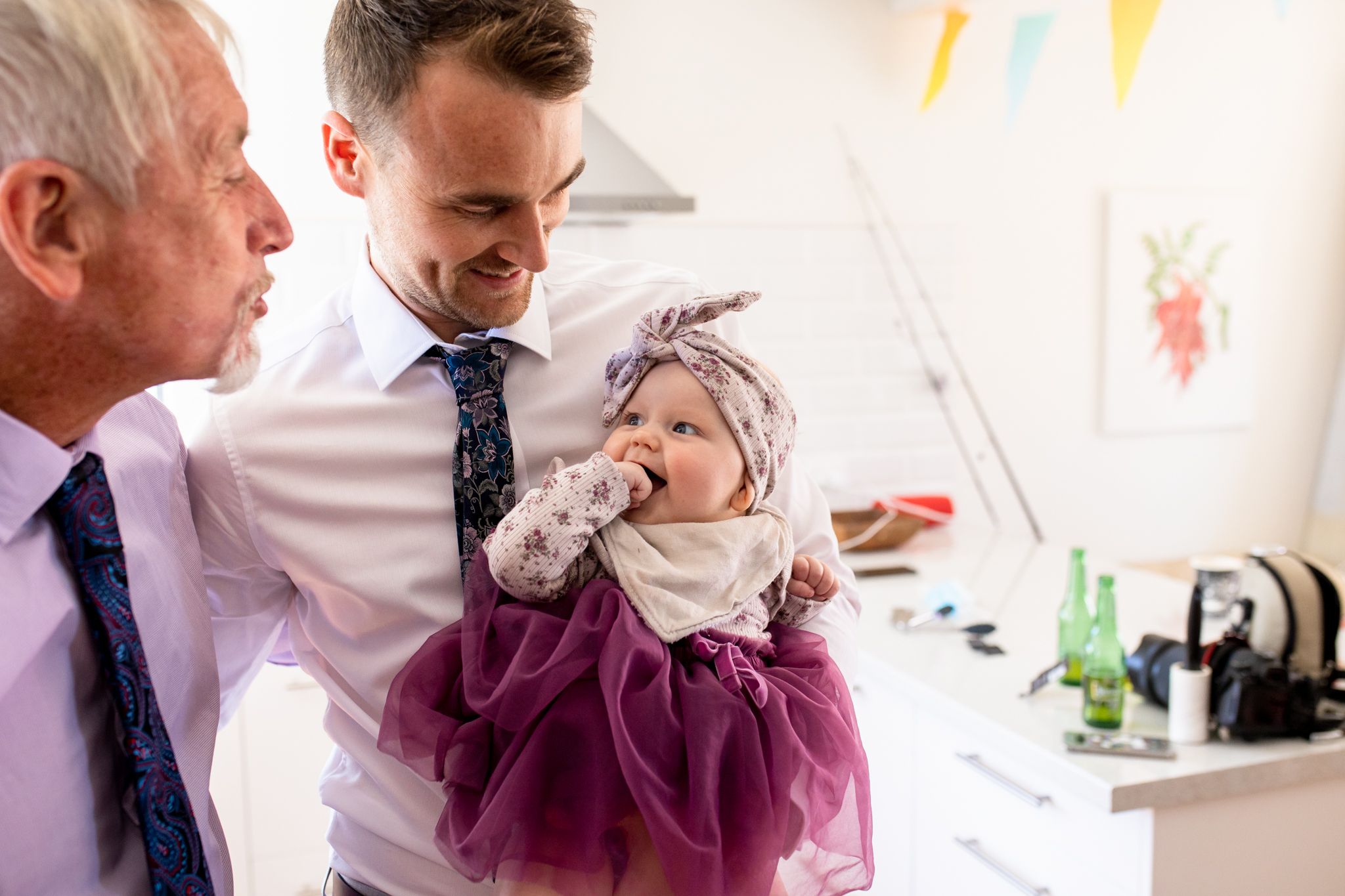 A heartwarming moment of getting ready in a bright indoor setting with decorative banners in the background.