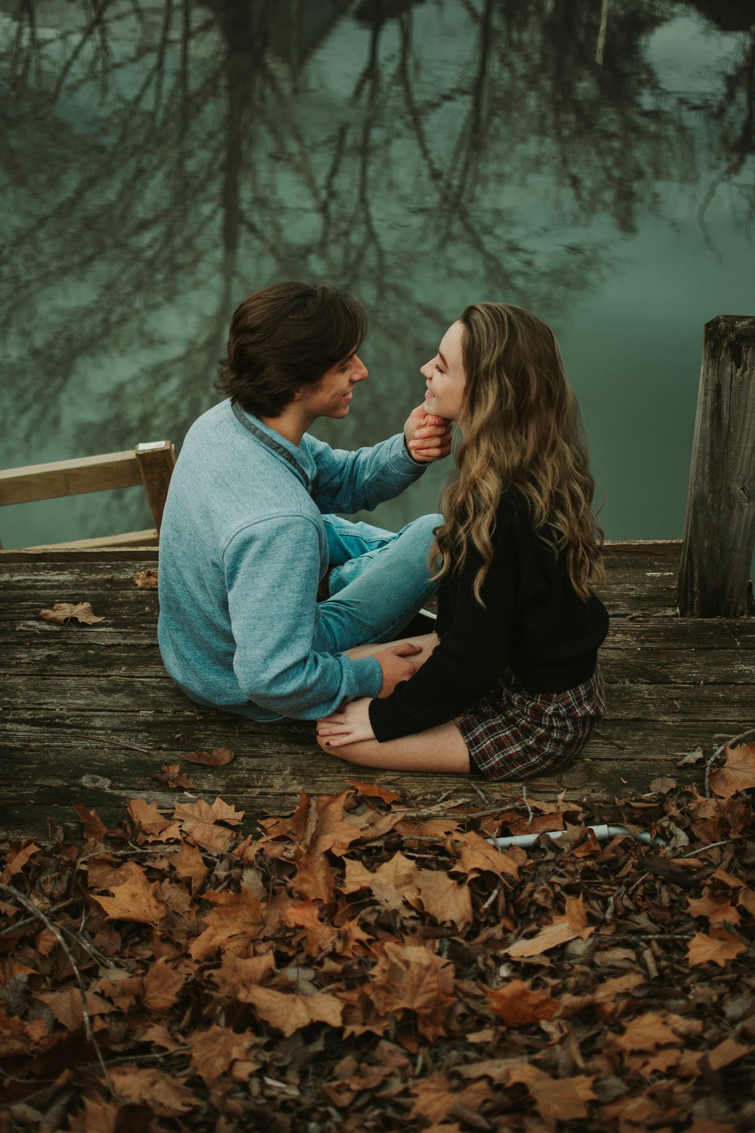 Moody fall elopement photos by the lake, Romantic couple portraits on dock, Intimate autumn elopement session.