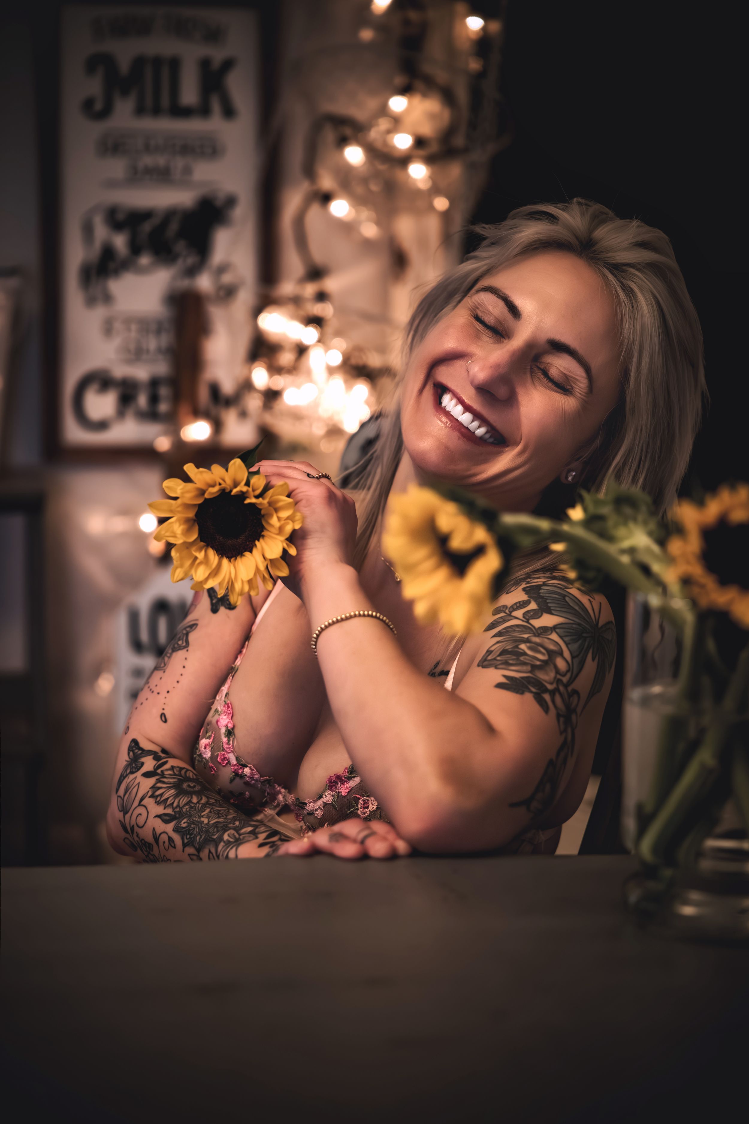 Intimate portrait photography with sunflowers and warm lighting creating romantic atmosphere.